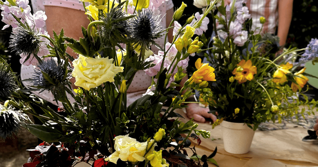 people creating floral masterpieces with spring blooms