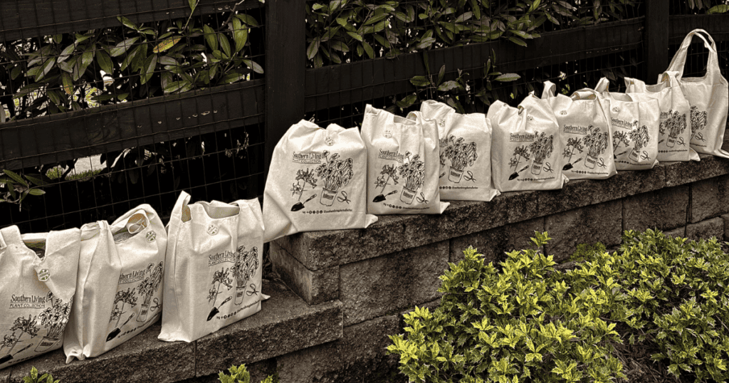 Southern Living swag bags lined up on a stone wall in a garden